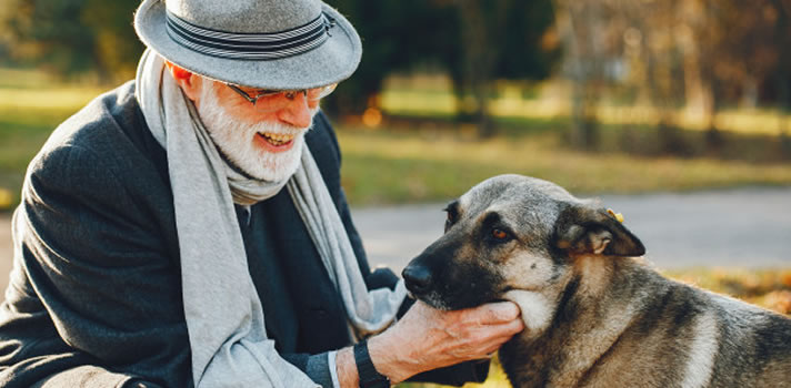 senior smiling at his dog