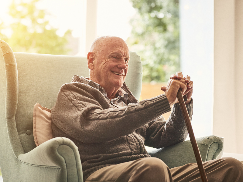 38 elderly man sitting and smiling