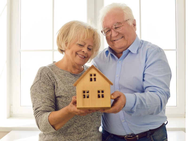Elderly women & man smiling at an object