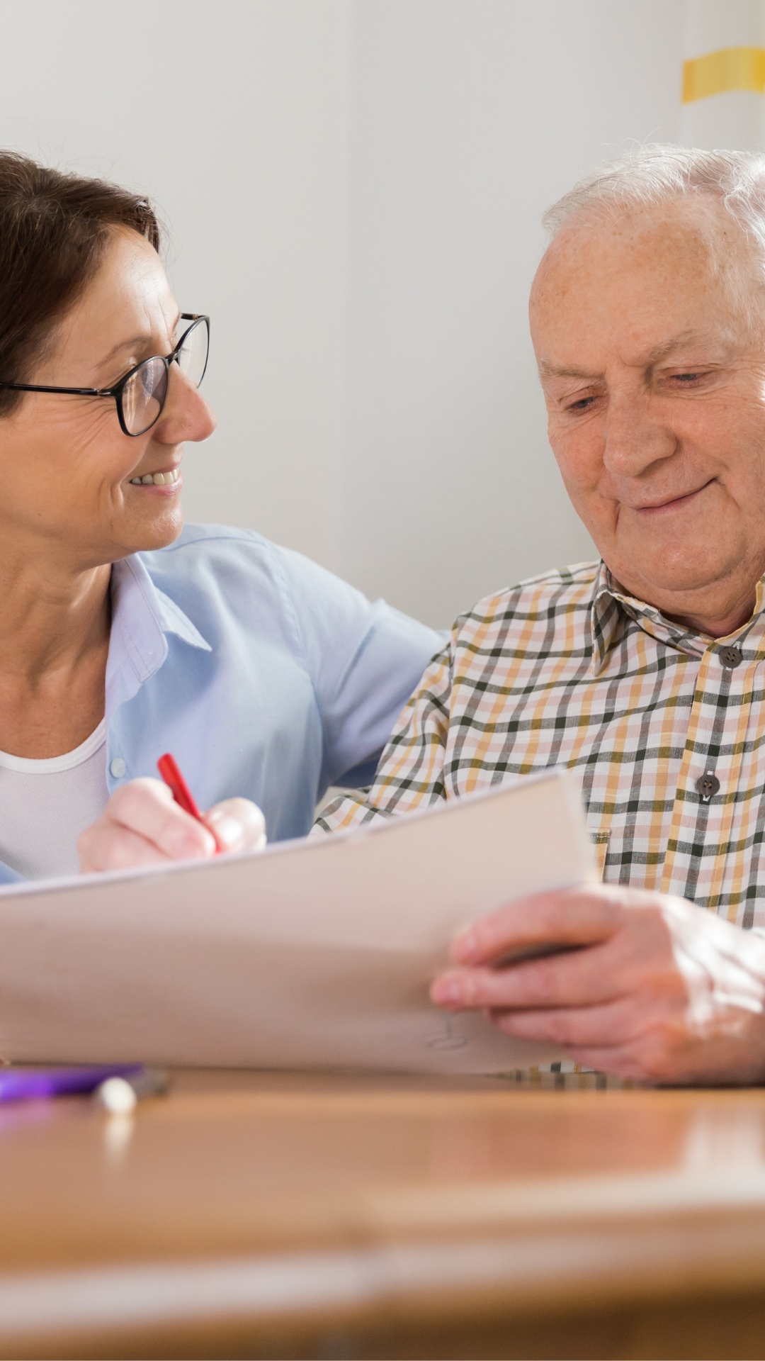 Untitled design (2) caregiver and senior reading