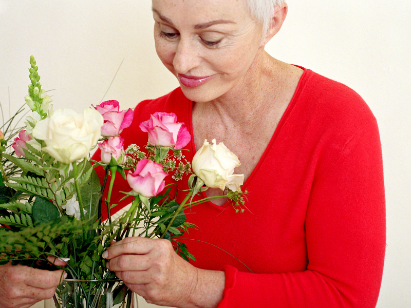 elderly smelling flower