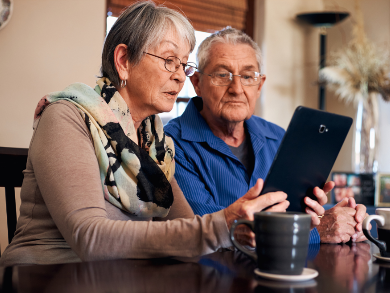 senior male and female looking at an old picture