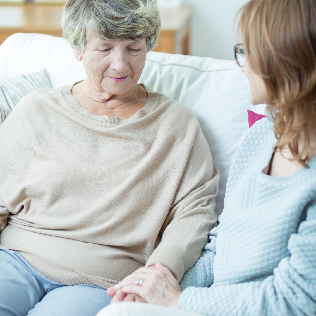 Adult daughter talking to senior mother