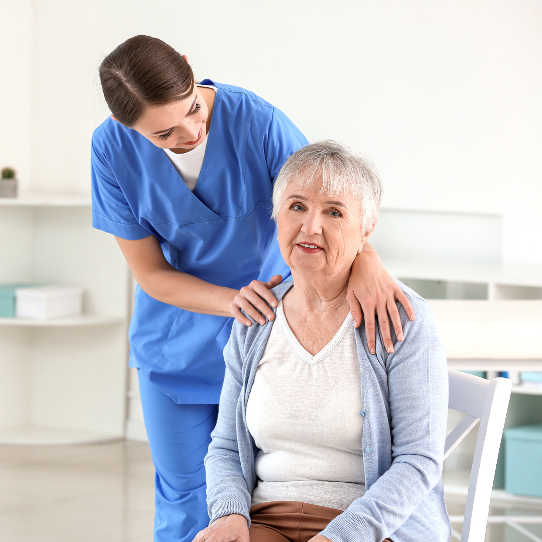 Female caregiver with Senior Woman Suffering from Parkinson