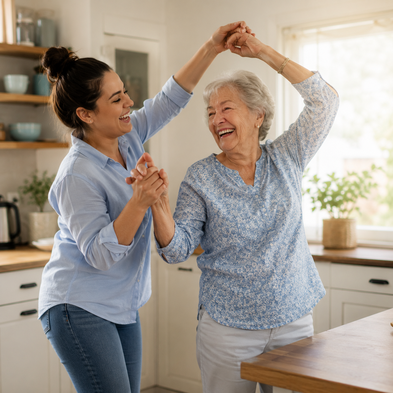 Laughing senior woman twirling under her granddaughter's arm while dancing together in a bright kitchen